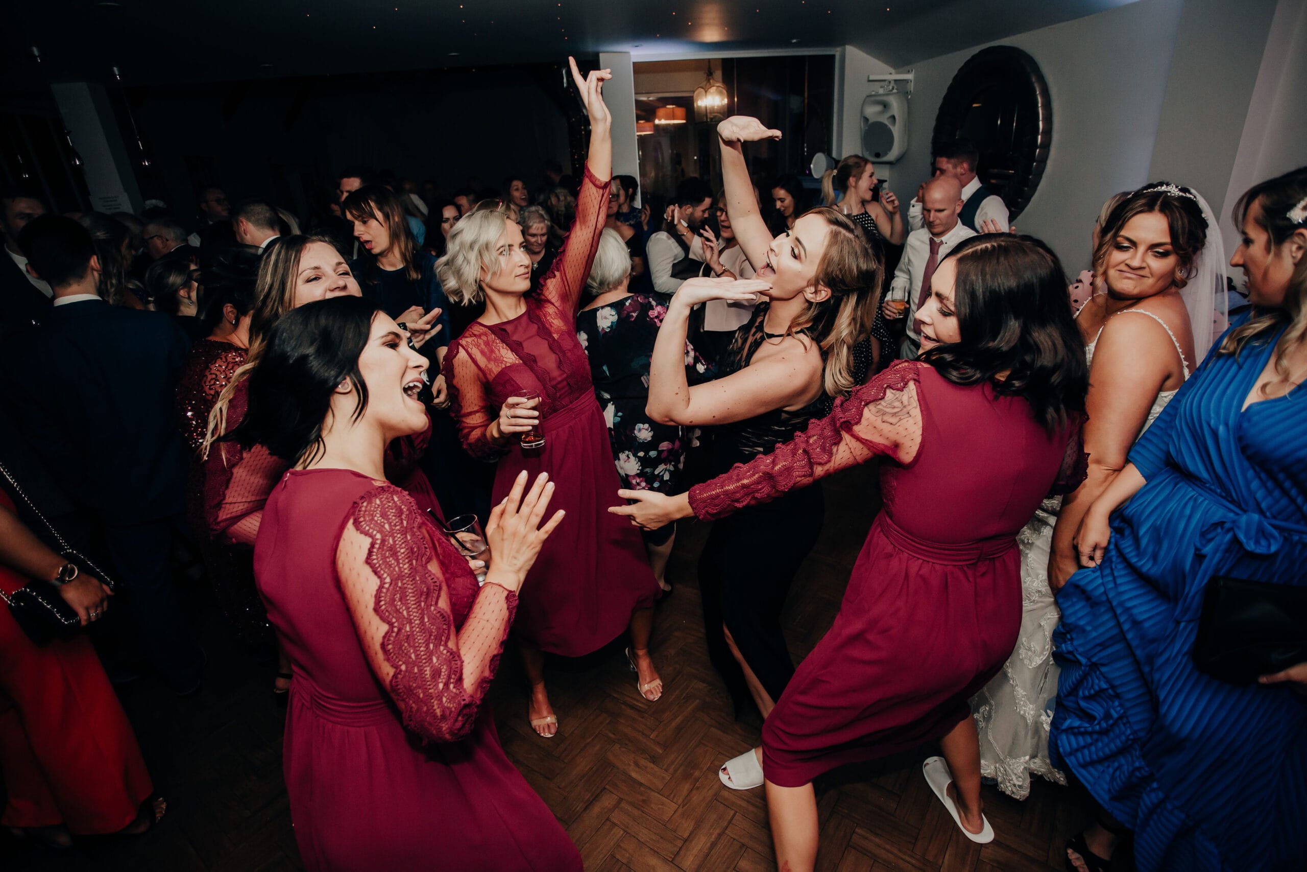Wedding guests celebrating on the dance floor at a reception